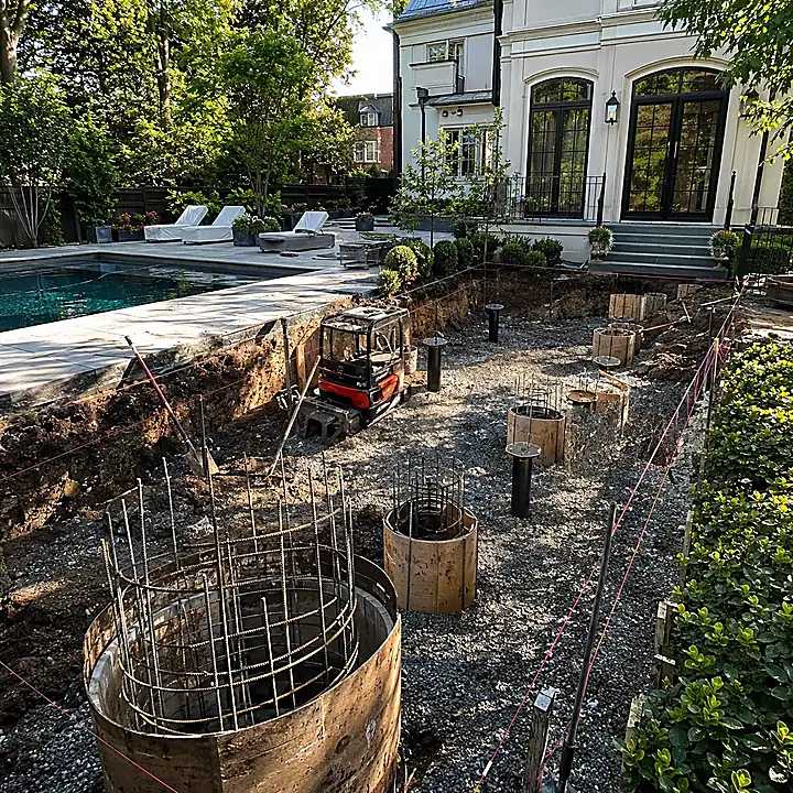 AM Developers LLC built concrete caissons and helical piers in Washington, DC, with rebar cages, drilled pier forms, excavation, gravel base, and foundation support