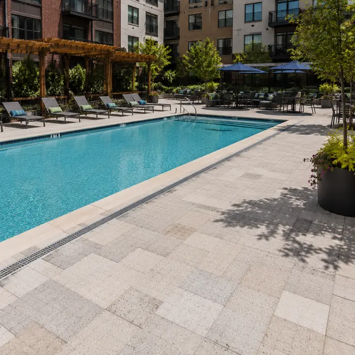 AM Developers LLC installed pool deck pavers with natural stone surrounds, slip resistant surfaces, and outdoor amenities in Washington DC